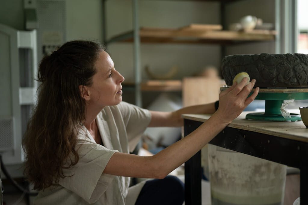 Celeste Ortelee working on a ceramic sculpture in her studio on Ishigaki Island