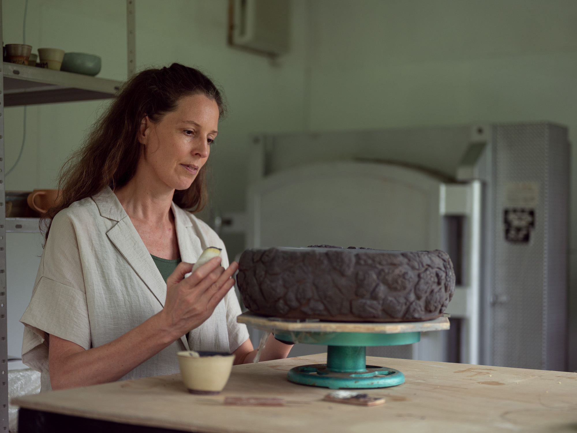 Celeste Ortelee working on a ceramic sculpture in her studio on Ishigaki Island, Japan.