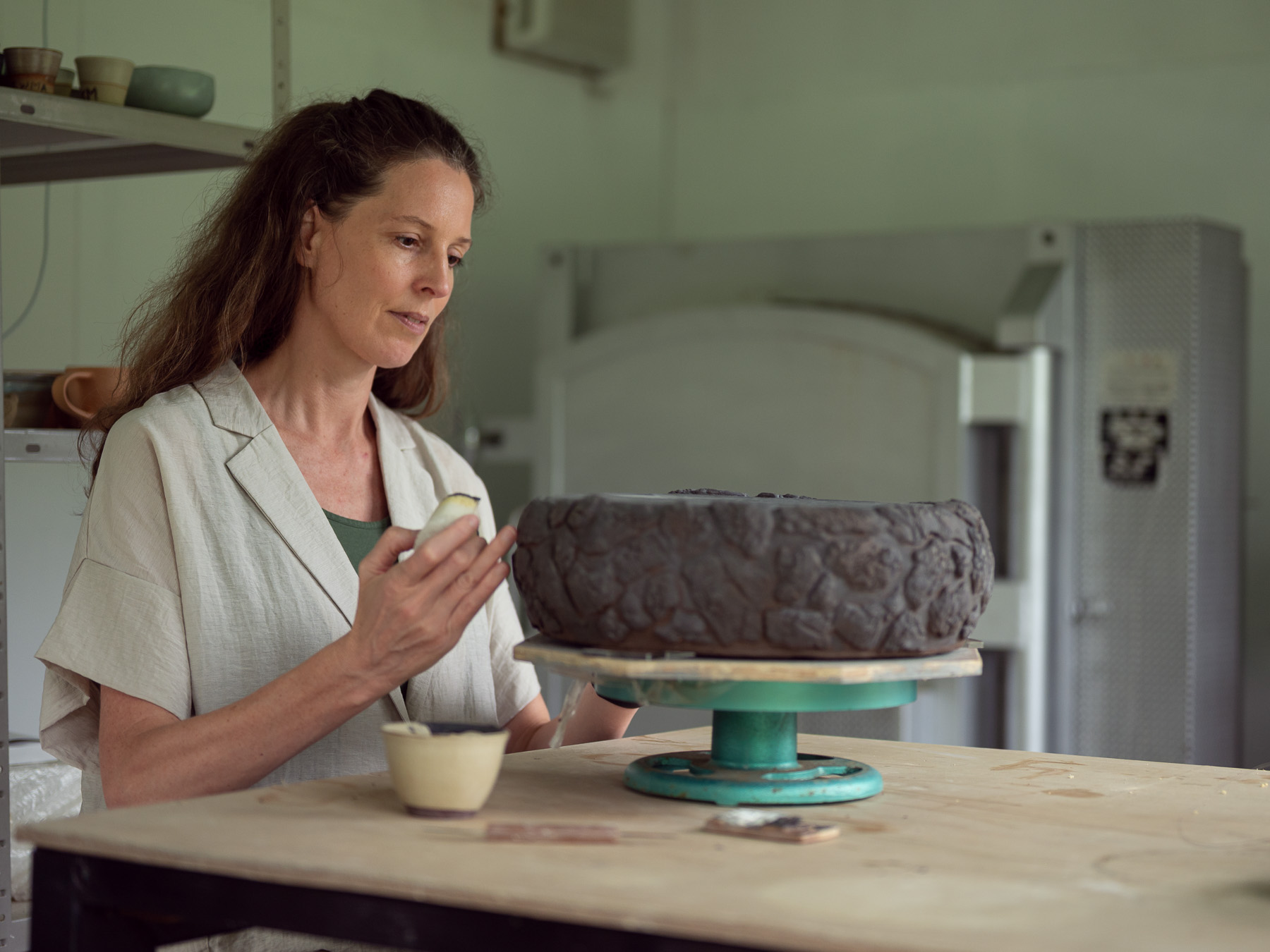 Celeste Ortelee working on a ceramic sculpture in her studio on Ishigaki Island, Japan.