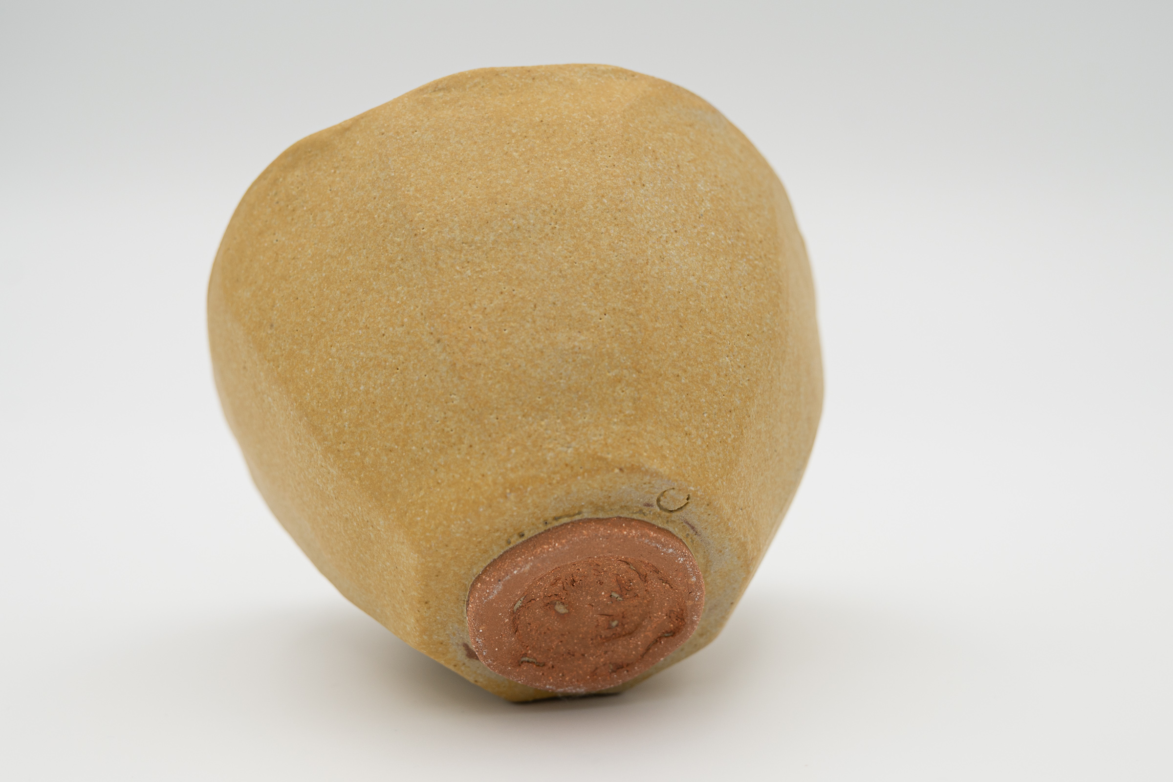 Underside of Unfolding, showing the reddish unglazed foot and maker's mark.